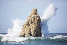A wave hits a rocky headland remnant during a swell at Back Beach, Karitane, Dunedin, New Zealand. Photo: Derek Morrison
