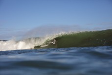 Caleb Cutmore drives deep as a spring swell hits The Ledge at Manu Bay, Raglan, Waikato, New Zealand.