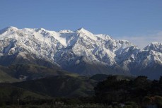 Snow-capped mountain peaks during the 2020 New Zealand Scholastics Surfing Championship held at a surf break near Kaikoura, New Zealand. Photo: Derek Morrison