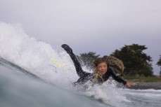 Rewa Morrison (13) bellyflops on a wave at a surf break near Kaikoura, New Zealand. Photo: Derek Morrison