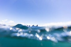 A waka ama team slices through water at Taronui Bay during the Pearl of the North waka ama race held near Te Tii, Northland, New Zealand.