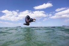 Chloe Groube flips off her board at Pauanui, Coromandel, New Zealand.