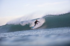Andy Sutherland drops in at a beachbreak near Gisborne, Eastland, New Zealand.