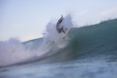 A surfer hits a lip at a beachbreak near Gisborne, Eastland, New Zealand.