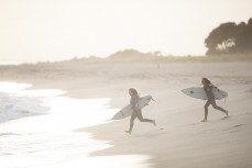Sisters Anna and Sophia Brock surf training at dawn at Mount Maunganui, Bay of Plenty, New Zealand. Photo: Derek Morrison