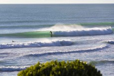 A surfer makes the most of a wave at a beachbreak near Gisborne, Eastland, New Zealand.