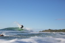 A surfer hits the lip at a beachbreak near Gisborne, Eastland, New Zealand.
