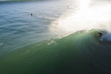 Darren Celliers gets slotted during a cyclone swell at Papamoa, Mount Maunganui, New Zealand.