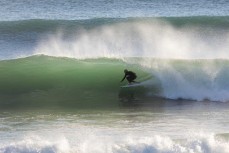 Darren Celliers gets slotted during a cyclone swell at Papamoa, Mount Maunganui, New Zealand.