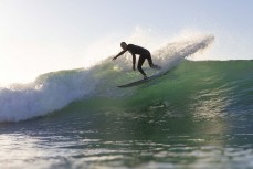 A surfer makes the most of a dawn surf at St Clair, Dunedin, New Zealand. Photo: Derek Morrison