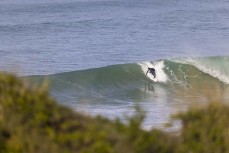 A surfer drops into a clean wall as the storm swell abates at Blackhead, Dunedin, New Zealand.Credit: www.boxoflight.com/Derek Morrison