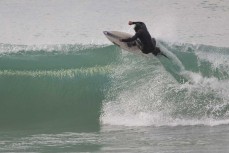 A surfer hits the end section during a winter session on the North Coast, Dunedin, New Zealand.Credit: www.boxoflight.com/Derek Morrison