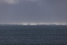 Sunlight on the horizon between squalls during a winter session on the North Coast, Dunedin, New Zealand.Credit: www.boxoflight.com/Derek Morrison