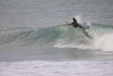 A surfer cranks off the top during a winter session on the North Coast, Dunedin, New Zealand.Credit: www.boxoflight.com/Derek Morrison