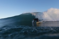 A surfer makes the most of clean waves during a winter session at Blackhead, Dunedin, New Zealand.