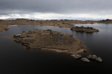 Huts on the Poolburn Reservior, Central Otago, New Zealand. Photo: Derek Morrison