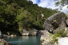 Sooz Fougere jumps off a rock at Denniston, Westport, West Coast, New Zealand.
