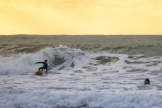 Dusty with dad Ian Ferguson during an afternoon session at Whale Bay, Raglan, Waikato, New Zealand.