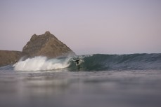 A surfer tucks into a barrel during a fun evening session in winter at Blackhead, Dunedin, New Zealand.Credit: Derek Morrison