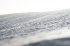 Spray droplets land on the back of a breaking wave during a fun evening session in winter at Blackhead, Dunedin, New Zealand.Credit: Derek Morrison