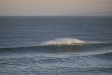 A surfer negotiates a challenging lineup at St Kilda, Dunedin, New Zealand.