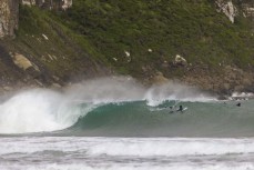 Keo Morrison and Max Wooffindin paddle over a set wave during a playful swell in the Catlins, Southland, New Zealand.Credit: Derek Morrison