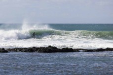 Kentaro Mitchell on a bomb during a fun swell near Ahipara, Northland, New Zealand.