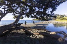 Keo and Rewa Morrison head for a dive at Leigh Marine Reserve on the east coast at Leigh, Auckland, New Zealand.