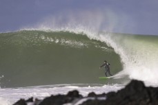 Dan Smith lines up a shack during a swell produced by Cyclone Gabrielle on the north coast of Dunedin, New Zealand.