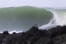 Richard O'Keefe draws off the bottom during a swell produced by Cyclone Gabrielle on the north coast of Dunedin, New Zealand.