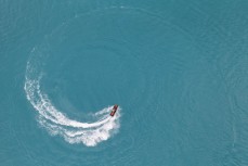 Stilts rides his jet ski on the glacial waters of Lake Ruataniwha near Twizel, Mackenzie Country, Canterbury, New Zealand.