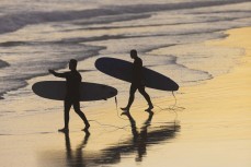 Surfers at dusk, Blackhead, Dunedin, New Zealand.
Credit: Derek Morrison