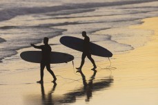 Surfers at dusk, Blackhead, Dunedin, New Zealand.Credit: Derek Morrison