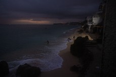 Surfers at first light at Bingin, Bali, Indonesia.