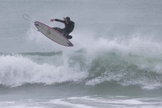 Ruben Peyroux takes flight during a fun winter swell at Whareakeake, Dunedin, New Zealand.Photo: Derek Morrison