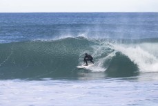 A surfer stalls for a barrel during a fun winter swell at Blackhead, Dunedin, New Zealand.Photo: Derek Morrison