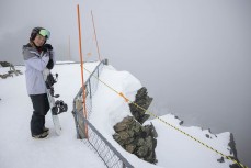 Rewa Morrison climbs to the top of a peak at The Remarkables ski field, Queenstown, Central Otago, New Zealand.