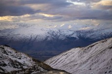 The lights of Coronet Peak sparkle from The Remarkables ski field, Queenstown, Central Otago, New Zealand.