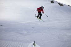 Ski patroller has fun on the way to work during early spring at The Remarkables ski field, Queenstown, Central Otago, New Zealand.