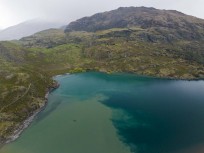 Discoloured water from recent rain as the Matukituki River enters Lake Wanaka, New Zealand.
