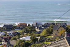 A wave breaks beyond the houses on Cliffs Road, St Clair, Dunedin, New Zealand.
Photo: Derek Morrison