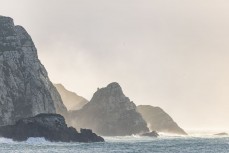 Sunshine filtering through rocks at a remote beachbreak in the Catlins, New Zealand. Photo: Derek Morrison