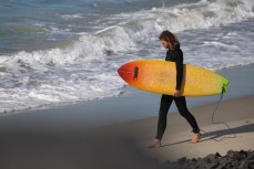 Colourful board during a fun swell at Blackhead, Dunedin, New Zealand.