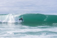 Josh Fairbairn airdrops into a barrel during a fun swell at Blackhead, Dunedin, New Zealand.