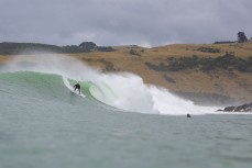 Jeff Patton drops into a wave during a swell produced by Cyclone Gabrielle on the north coast of Dunedin, New Zealand.