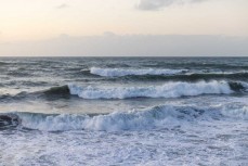 Sunset as a large north swell sweeps into Tauranga Bay, Westport, West Coast, New Zealand.