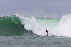 Sam Blackman gets caught behind at a remote reef break in the Catlins, New Zealand. Photo: Derek Morrison