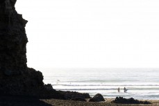 Chloe and Lola Groube head out for a freesurf at Piha, Auckland, New Zealand.