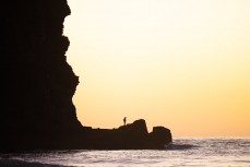 Fisherman at Piha, Auckland, New Zealand.