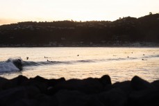 A surfer makes thermost of a new sas it well wraps into south-facing beaches in Wellington, New Zealand.